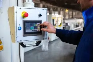 alt: Irvine, CA electrician adjusting generator control panel for backup power