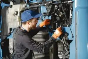 alt:Irvine, CA electrician repairing generator belt for reliable backup power